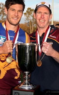 Nathan Clarke holds aloft the 2012 NEAFL Premiership Cup with Cheynee Stiller